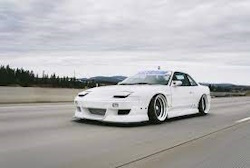 white 240sx on road with sleepy headlights