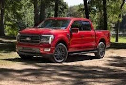 red f-150 wiht nice trees in background